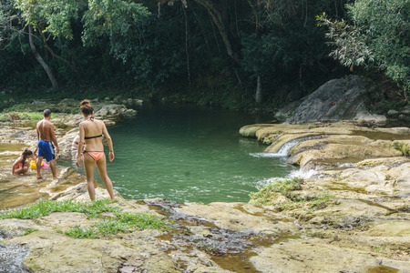 Las Terrazas, Cuba â December 28, 2016: tourist relaxing on natural pool in rio san juan , las terrazas pinar del rioのeditorial素材