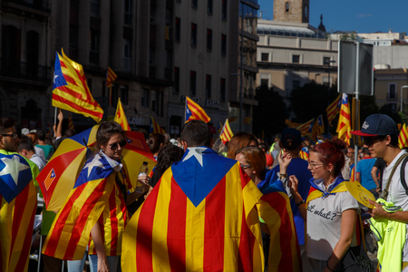 Barcelona, Catalonia, Spain, September 11, 2017: People on street on riot during national day from Catalonia claming for independence of Catalunya in Barcelona with catalan flags. Editorial captionのeditorial素材
