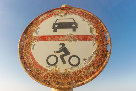 old traffic signal with sky at background. Not allowed cars and motorcycles.の写真素材