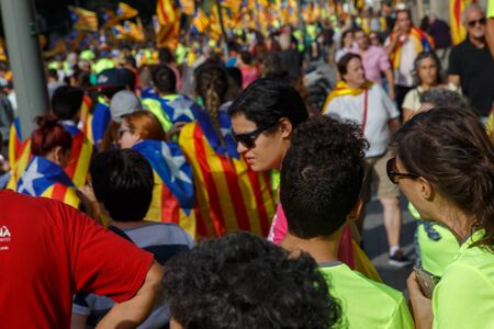 Barcelona, Catalonia, Spain, September 11, 2017: People on street on riot during national day from Catalonia claming for independence of Catalunya in Barcelona with catalan flags. Editorial captionのeditorial素材
