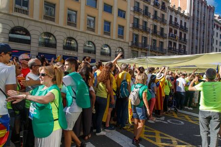 Barcelona, Catalonia, Spain, September 11, 2017: People on street on riot during national day from Catalonia claming for independence of Catalunya in Barcelona with catalan flags. Editorial captionのeditorial素材