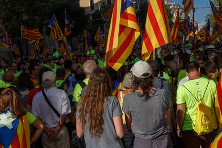 Barcelona, Catalonia, Spain, September 11, 2017: People on street on riot during national day from Catalonia claming for independence of Catalunya in Barcelona with catalan flags. Editorial captionのeditorial素材