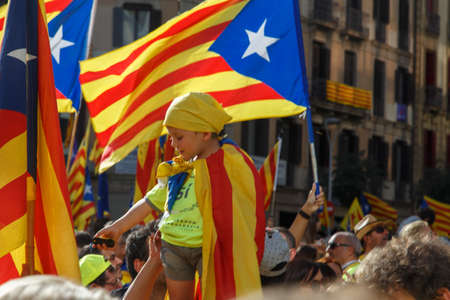 Barcelona, Catalonia, Spain, September 11, 2017: People on street on riot during national day from Catalonia claming for independence of Catalunya in Barcelona with catalan flags. Editorial captionのeditorial素材