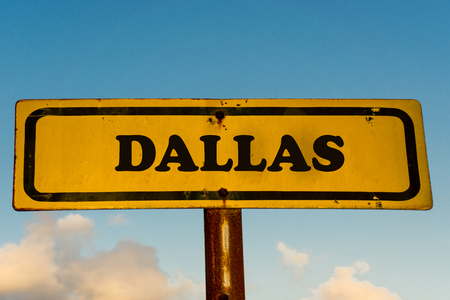 Dallas city street old antique yellow sign with blue sky at background, USA signal city series.の写真素材