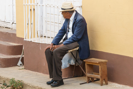 Trinidad, Cuba, January 3, 2017:  old man on street smooking a cigarのeditorial素材