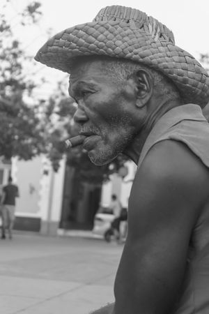 Trinidad, Cuba, January 3, 2017:  old man on street smooking a cigarのeditorial素材