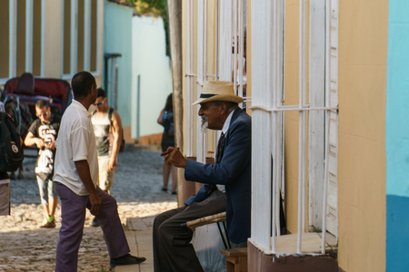 Trinidad, Cuba, January 3, 2017:  old man on street smooking a cigarのeditorial素材