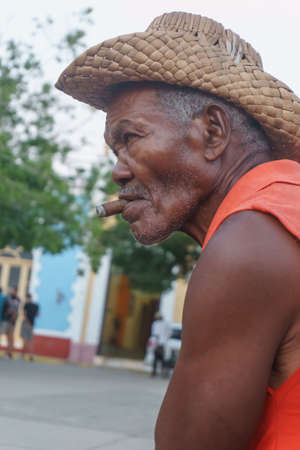 Trinidad, Cuba, January 3, 2017:  old man on street smooking a cigarのeditorial素材