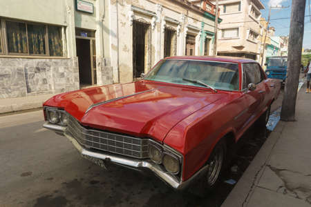 Santa Clara, Cuba, January 5, 2017: Red car on street. Typical cuban travel imagery picture. Old red car from Cubaのeditorial素材