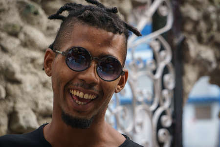 La Havana, Cuba, January 08, 2017:  Portrait of a black cuban man with sunglasses on street from la Havana. Afrocaribbean rasta cultureのeditorial素材