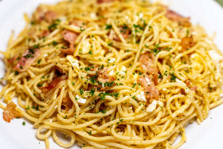 Selective focus on a dish of spaghetti carbonaraの写真素材