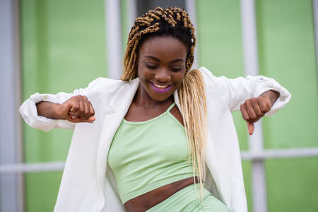 Smiling beauty african woman dancing while smile outdoorsの写真素材