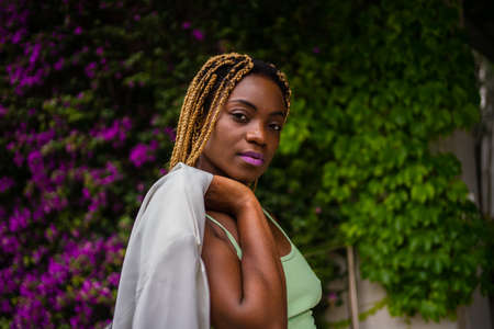 Sensual african sportive woman facing the camera while posing outdoorsの写真素材