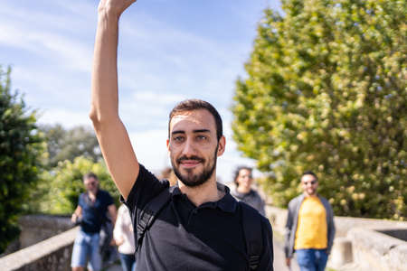 tour guide leading a group of tourist during the visit on an historical placeの写真素材