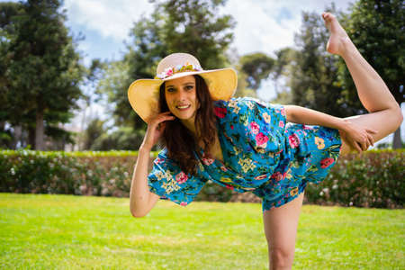 Woman raising the leg while performing a a dance choreography outdoorsの写真素材