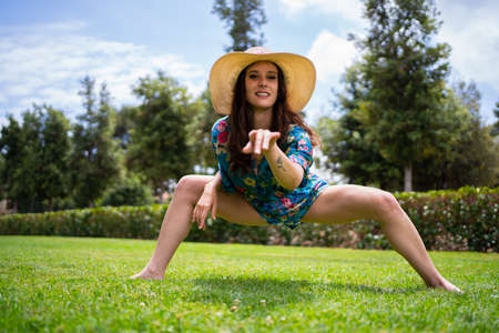 Woman pointing ahead while dancing freestyle in a gardenの写真素材