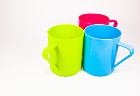 The close up image of three colorful plastic cups with the white backgroundの写真素材