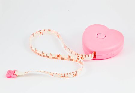 The lovely pink heart measuring tape on the white backgroundの写真素材