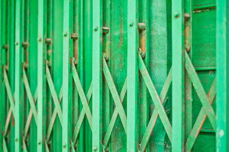 The closeup image of the green metal shutter gate