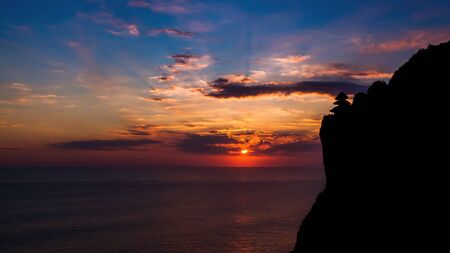 Sunset view with a temple silhouette from a distant.の写真素材