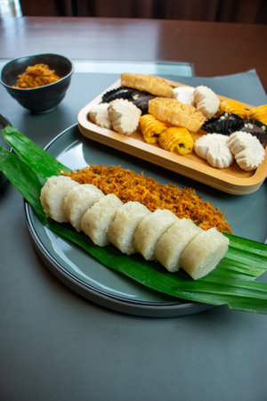 Sticky rice or traditional lemang made from glutinous rice, coconut milk, and salt, cooked in a hollowed bamboo tube coated. Eat with spicy shredded coconut on a plate.の写真素材