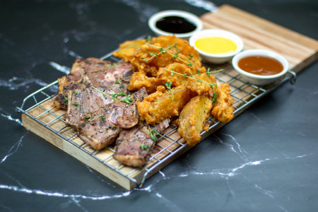Mint Marinated Lamb Cutlets with potato wedges on black background, all about grilled for your festive.の写真素材