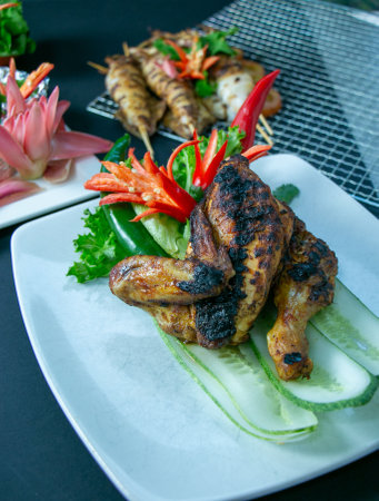 Grilled chicken wings on white plate, Thai style food.の写真素材