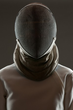 Studio portrait of fencing athlete wearing face protective maskの写真素材