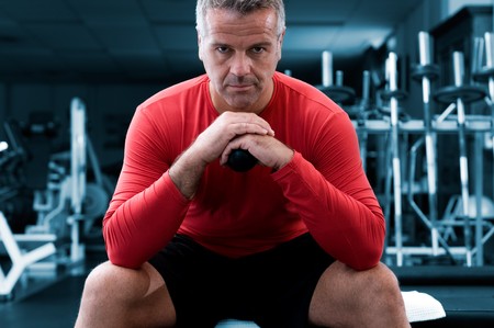 Concentrated mature man looking at camera at gymの写真素材
