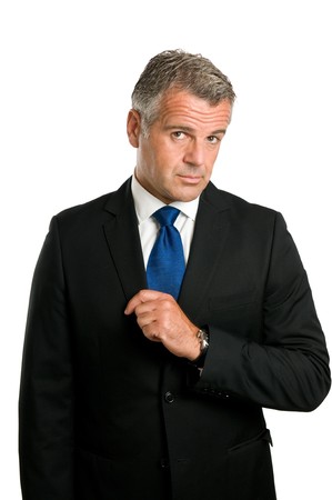 Mature businessman looking at camera with a worried and puzzled expression isolated on white backgroundの写真素材