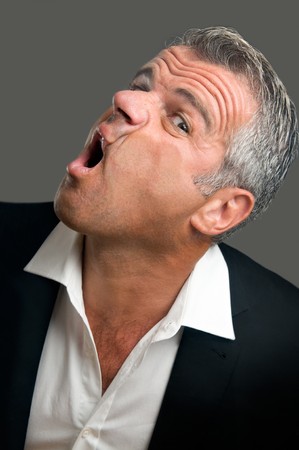 Mature man splattered behind a glass window with suffering and funny expressionの写真素材