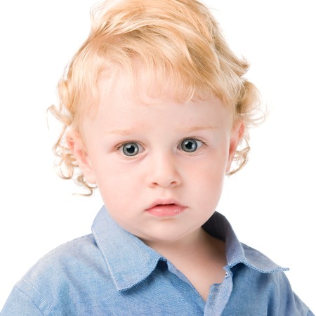 Portrait of little beautiful kid absorbed isolated on white backgroundの写真素材