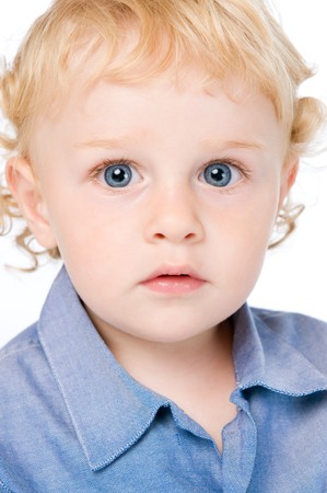 Portrait of little beautiful kid absorbed isolated on white backgroundの写真素材