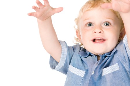 Smiling happy beautiful little child raising arms with joy isolated on white backgroundの写真素材
