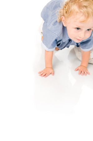 Beautiful little baby crawling and trying to stading up isolated on white backgroundの写真素材