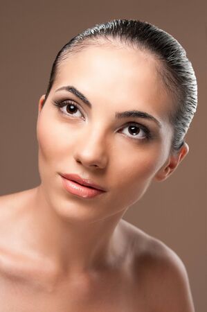 Fashion beauty female model lokking away on brown background, perfect skin and makeupの写真素材