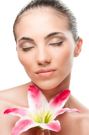 Beautiful lady relaxing with lily flower isolated on white background, professional beauty makeupの写真素材