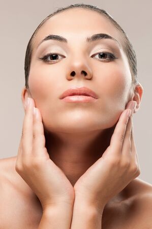 Fashion and beauty female model looking at camera on gray background, perfect skin and makeupの写真素材