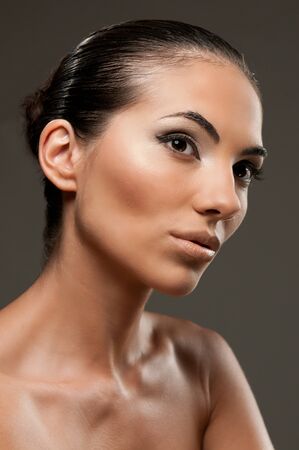 Fashion and beauty model portrait over gray background, perfect professional makeupの写真素材