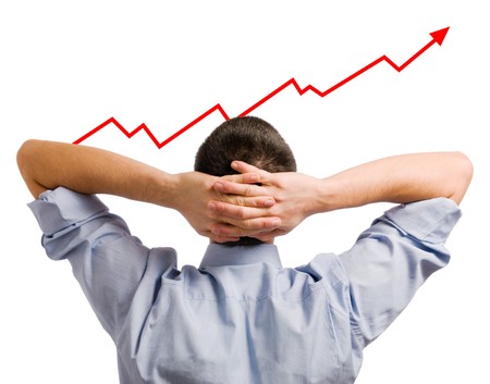 Young businessman looking at his growing share. Healthy and successful business!の写真素材