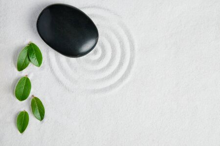 Zen garden background with copy space for your text. Pebble and leaf for relax and meditation.の写真素材