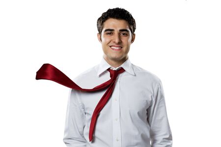 Young businessman smiling at camera with blowing necktie. Good business in action!の写真素材