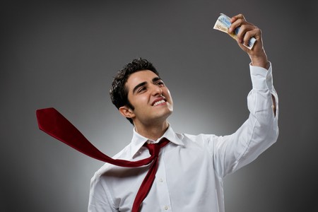 Happy businessman with bundle of euro money, good business!の写真素材