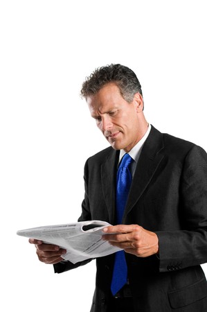 Mature businessman reading morning news with concentration isolated on white backgroundの写真素材