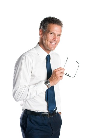 Mature man smiling while holding a pair of glasses isolated on white backgroundの写真素材