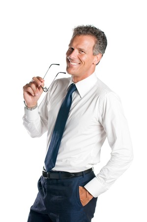 Smiling senior businessman holds a pair of glasses, isolated on white backgroundの写真素材