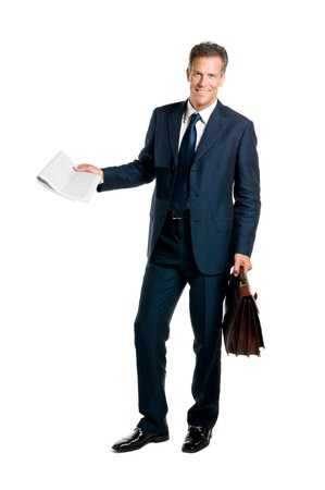 Mature businessman standing with a newspaper and briefcase in hand isolated on white backgroundの写真素材