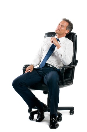 Dreamful pensive businessman sit on his business chair isolated on white backgroundの写真素材