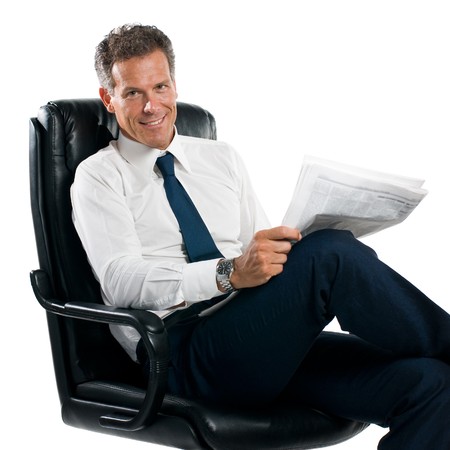 Businessman reading news sit in his chair isolated on white backgroundの写真素材