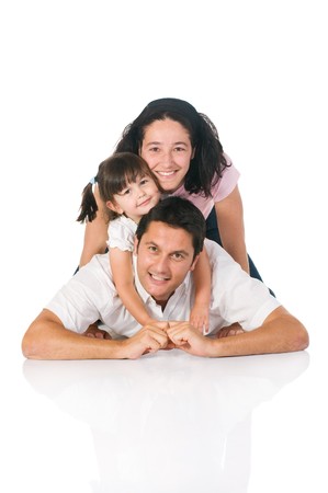 Happy smiling family lying down together isolated on white backgroundの写真素材